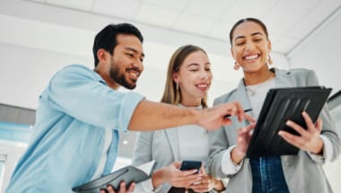 Healthcare professionals looking at continuing education programs displayed on tablet